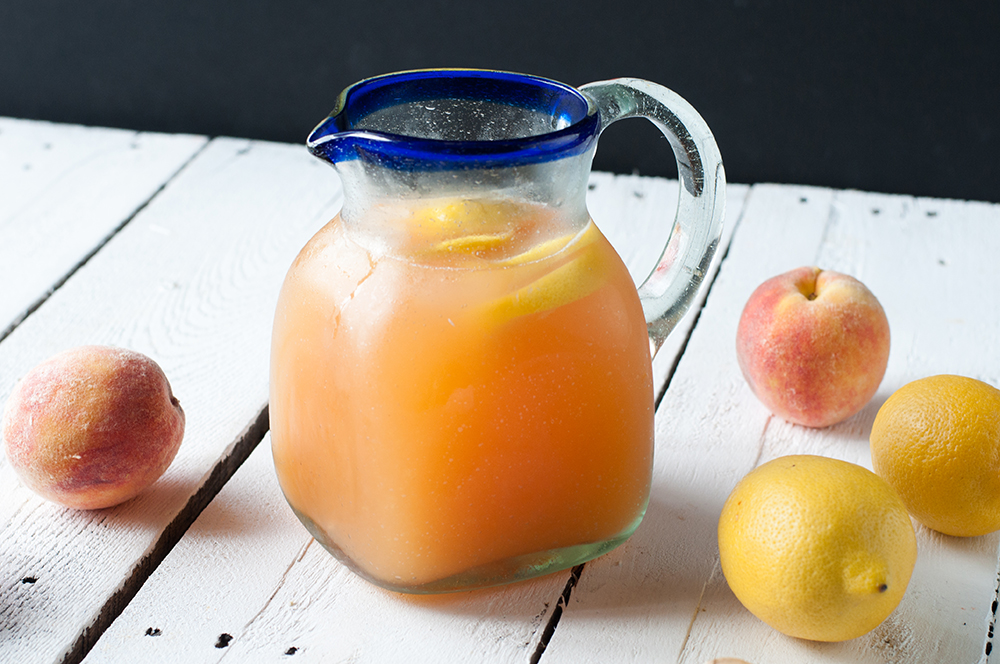 Enjoy a glass of Ginger Peach Lemonade on a hot summer day. Fresh ginger adds a pop of flavor that compliments that peaches. #summer #drink 