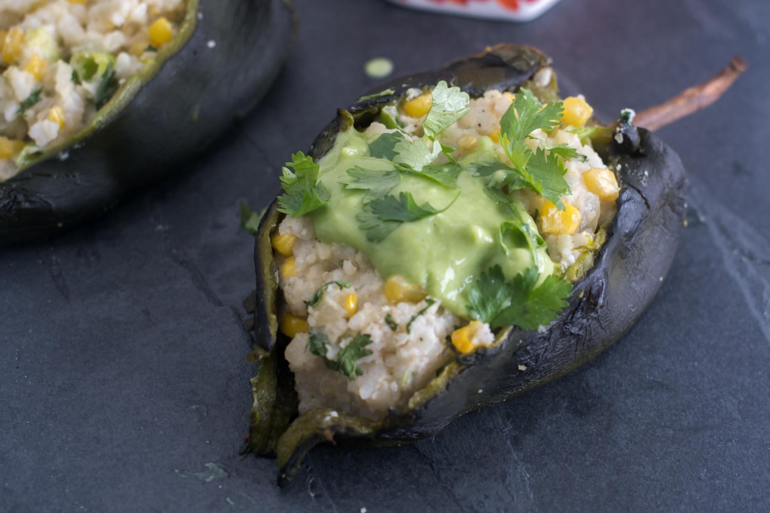 Roasted poblano peppers are stuffed with a creamy, rice filling. I like to serve these with an avocado and tomatillo salsa. #vegan #glutenfree