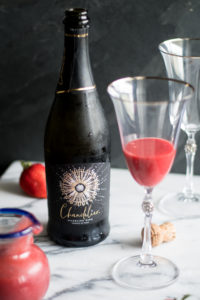 Strawberry Bellini is a twist on the classic peach bellini which is made with peach puree and sparkling wine. Instead of using peach puree, this cocktail uses a strawberry puree. #wine #summer #cocktail
