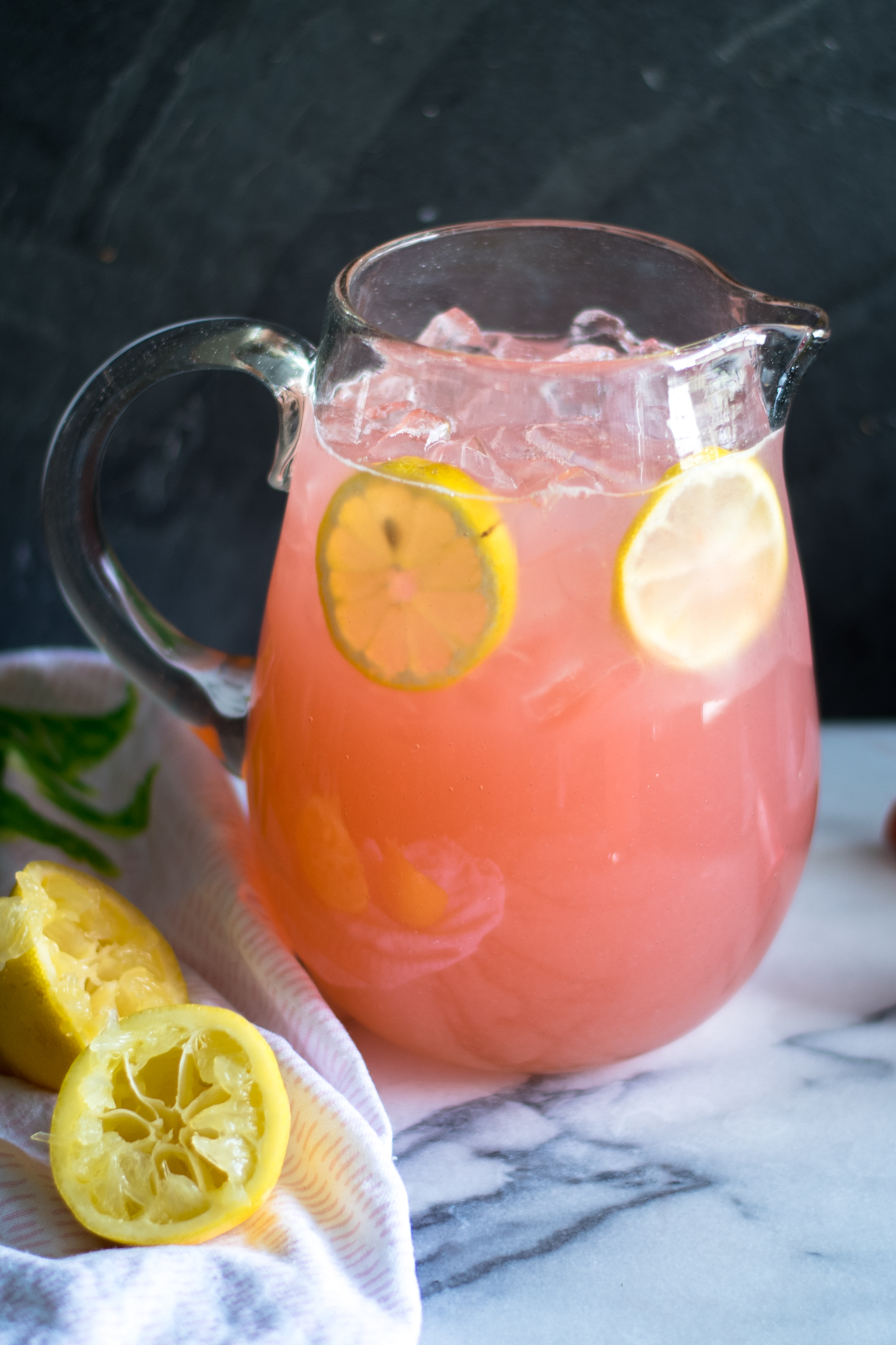 Light, refreshing lemonade made with rhubarb simple syrup. The perfect way too cool down on a hot summer day. #summer #recipe #rhubarb #lemonade #lemon #drink #vegan