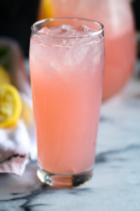 Light, refreshing lemonade made with rhubarb simple syrup. The perfect way too cool down on a hot summer day. #summer #recipe #rhubarb #drink #vegan #lemonade