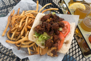 Vegan Po'Boy Sandwich with fries at Pug Minds Brewery