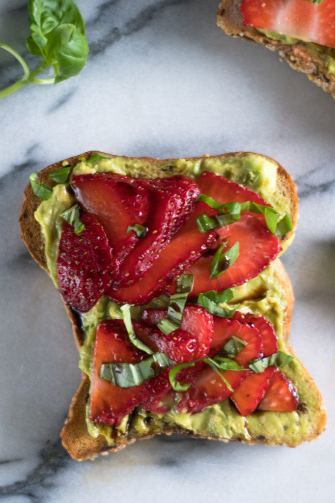 This Strawberry Avocado Toast is perfect for any spring brunch! Sliced strawberries, fresh basil, and balsamic vinegar take this toast to the next level! #avocado #vegan #glutenfree #vegetarian