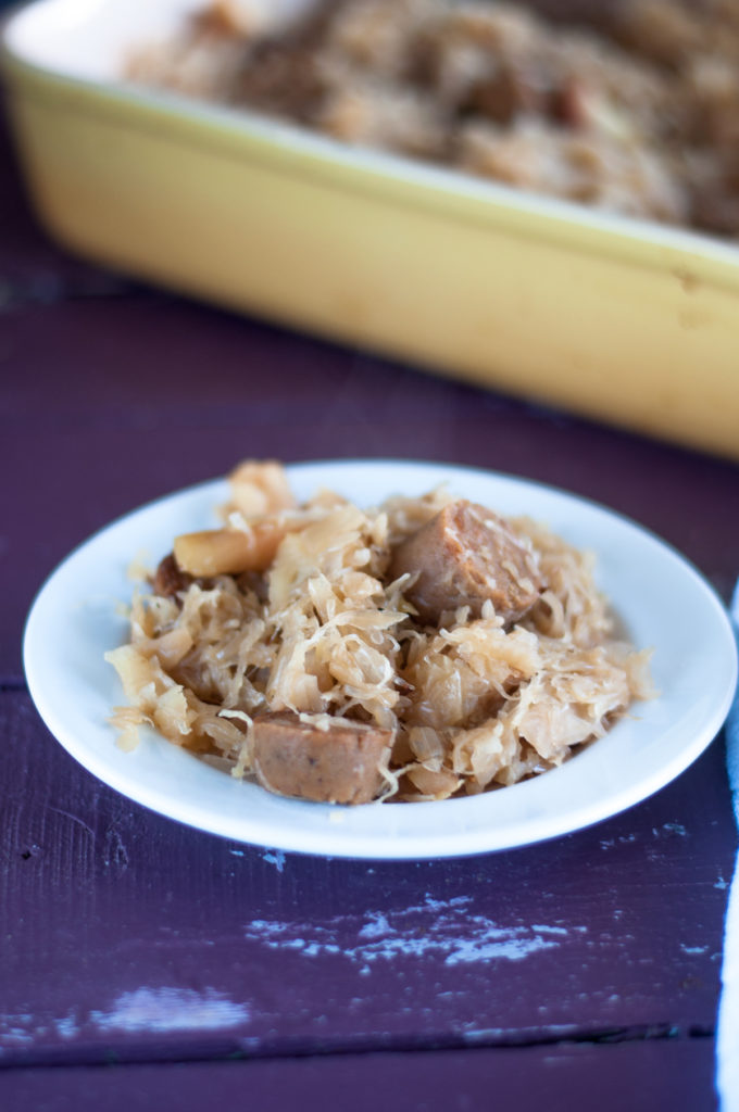 This Vegan Sauerkraut and Bratwurst Casserole is a cozy casserole that is perfect for the cooler weather. It is loaded with vegan bratwurst sausages, onion, apples, and lots of sauerkraut!  #vegan #casserole #sauerkraut #German #vegetarian #fall #food #dinner