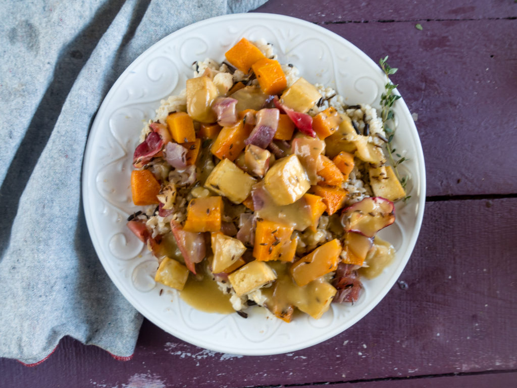 Looking for an easy sheet pan dinner? This fall focused recipe features Roasted Butternut Squash, Apples, and Tofu topped with an apple cider gravy.