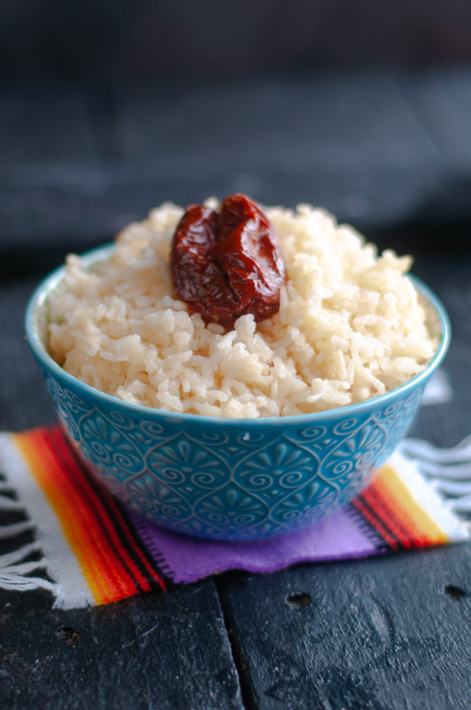 Chipotle White Rice takes basic white rice and elevates it by adding in a whole chipotle pepper. It adds a nice spiciness to the rice. A Perfect side dish for taco night! #side #recipes #easyrecipe #rice #glutenfree #vegan #vegetarian #VeganMexican