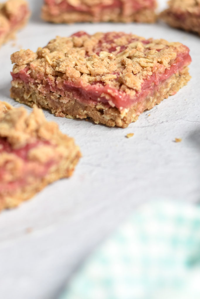 Rhubarb Crumb Bars are the perfect portable sweet treat for any potluck or picnic. Simple rhubarb filling sandwiched between the crust and crumb topping!