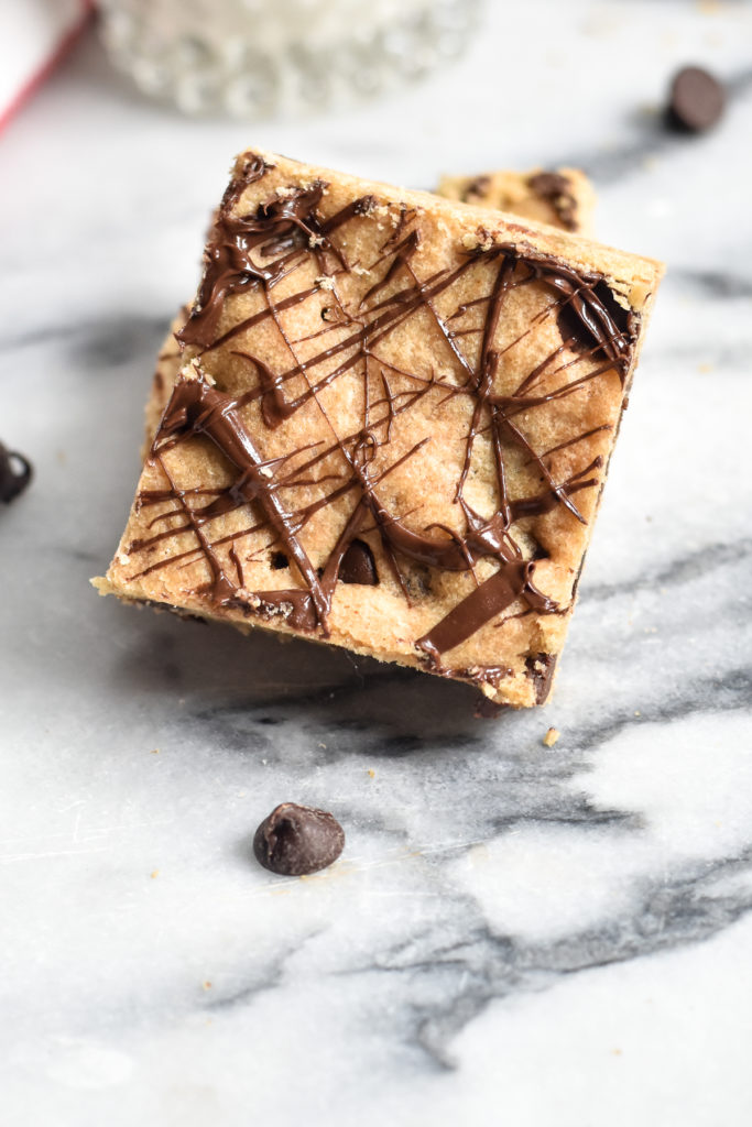 Chocolate drizzled chocolate chip cookie bar is great for holiday baking season. 
