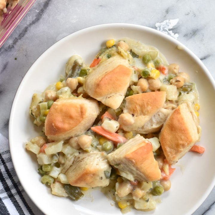 Easy, comforting Biscuit Veggie Pot Pie is my spin on a classic pot pie. Canned biscuits make this casserole and easy dinner recipe!