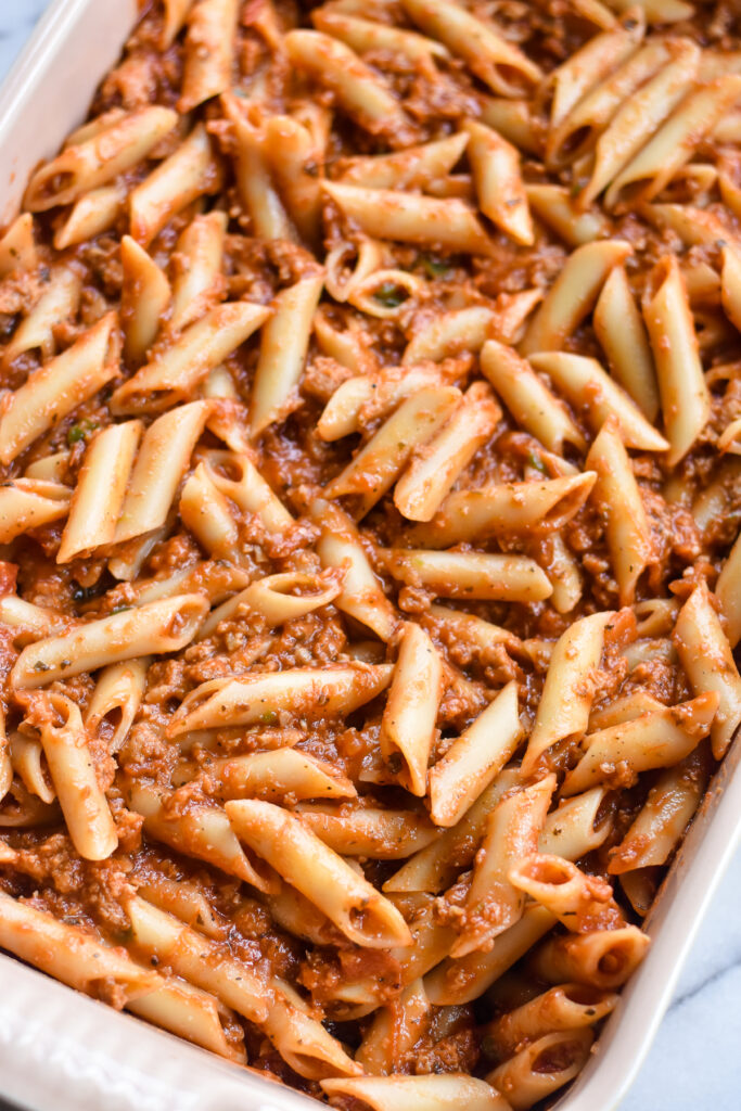 This baked pasta features noodles, spicy vegan sausage, marinara sauce, and vegan cheese. 