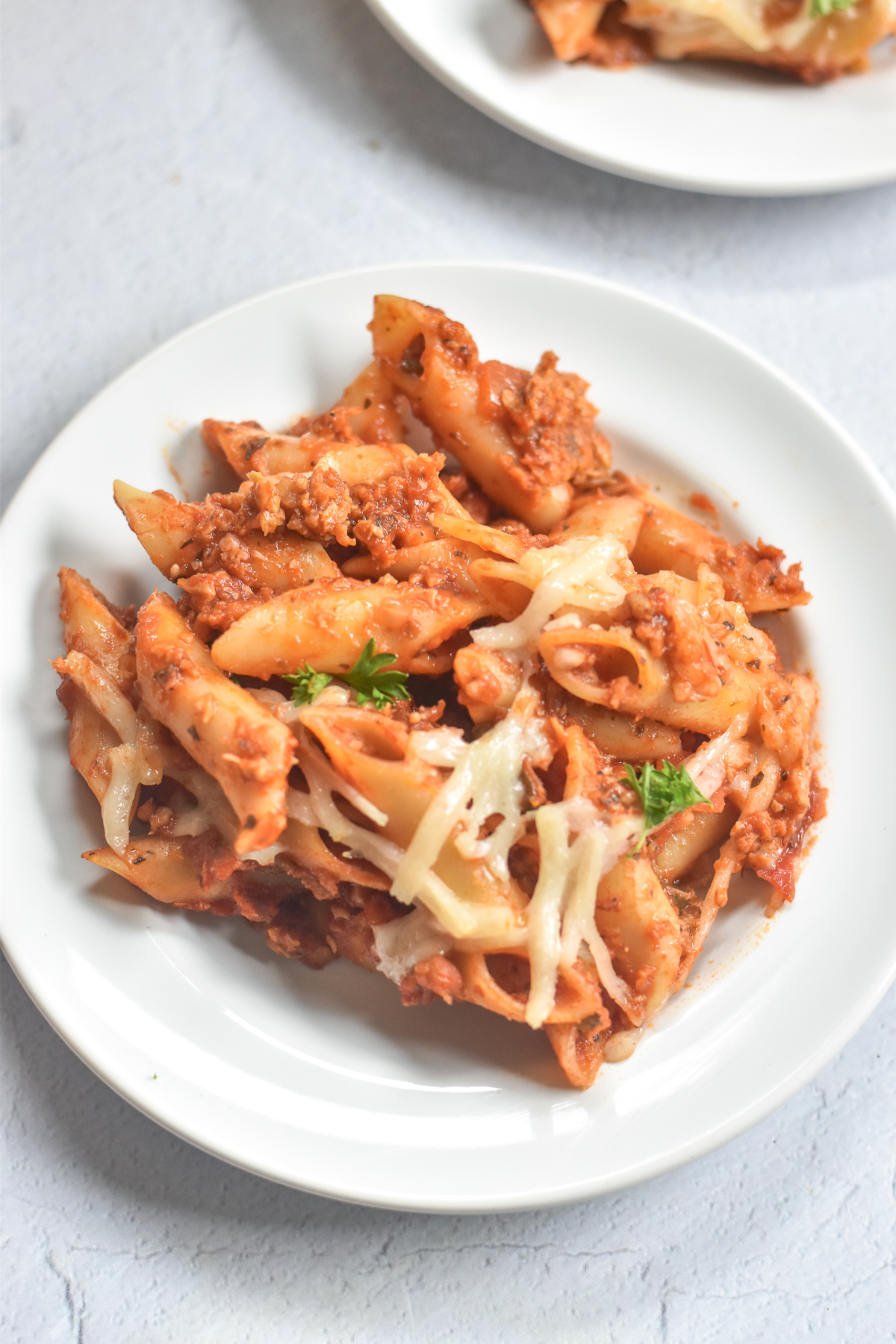 A classic Midwestern inspired casserole—Vegan Baked Mostaccioli is an easy baked pasta recipe featuring Mostaccioli noodles, spicy vegan sausage, marinara sauce, and vegan cheese.