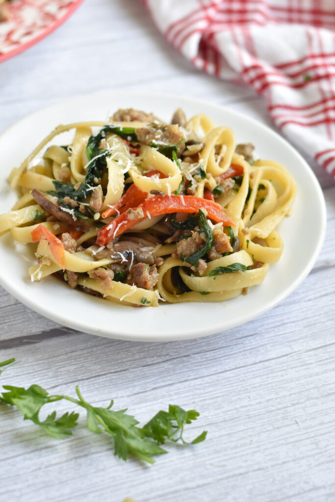 Fettuccini noodles tossed with Italian sausage, mushrooms, spinach is a delicious pasta recipe full of flavor. 