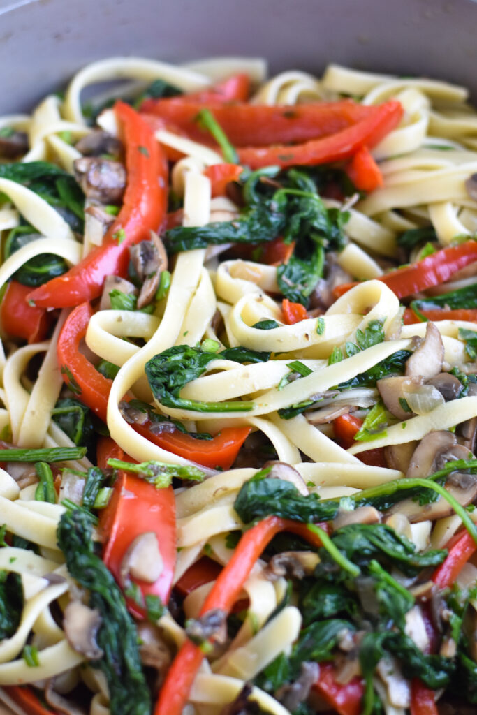 Fettuccine noodles with mushrooms and spinach is a hearty vegetarian pasta recipe. 
