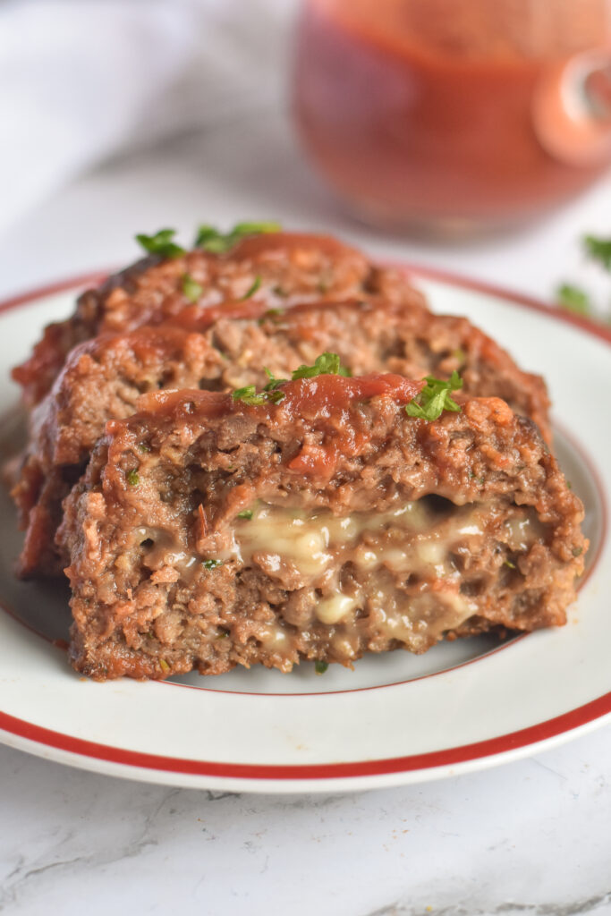 Sliced Vegan Impossible Meatloaf stuffed with vegan cheese. 