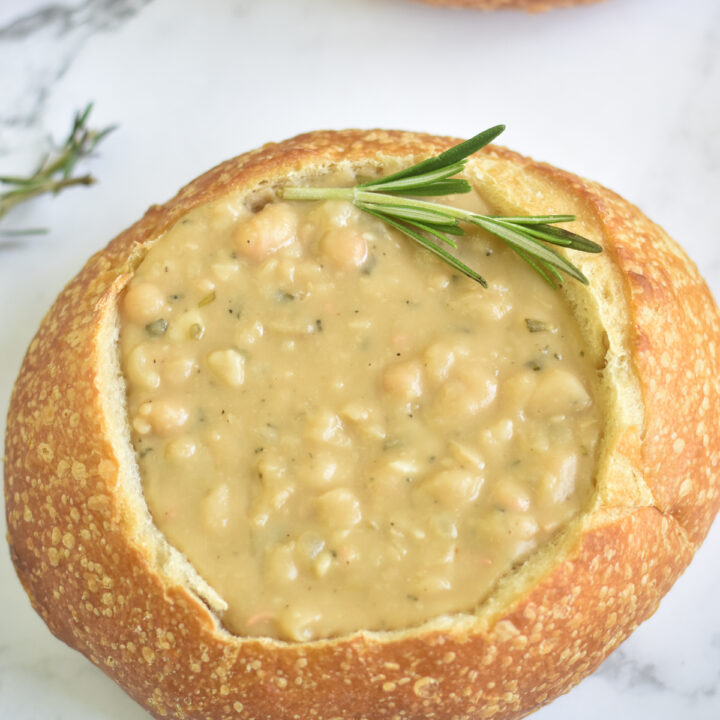 White beans are infused with aromatic rosemary for a flavorful bowl of soup. Fresh rosemary takes bean soup to the next level.